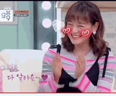 a woman with hearts on her cheeks is smiling in front of a sign that says g9