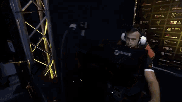 a man wearing headphones and a g2a shirt