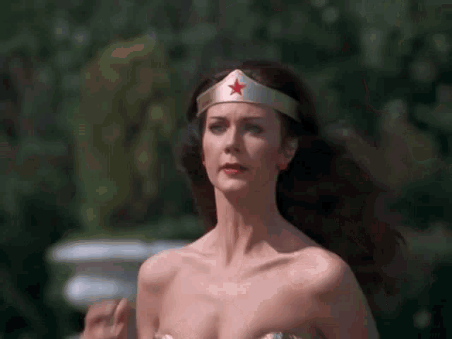 a woman in a wonder woman costume with a red star on her head .
