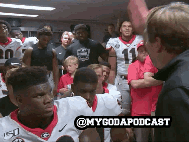 a group of football players are gathered in a locker room with the hashtag @mygodapodcast