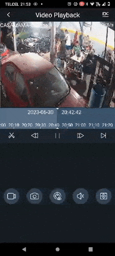 a screenshot of a video playback on a cell phone shows a red car in a garage .