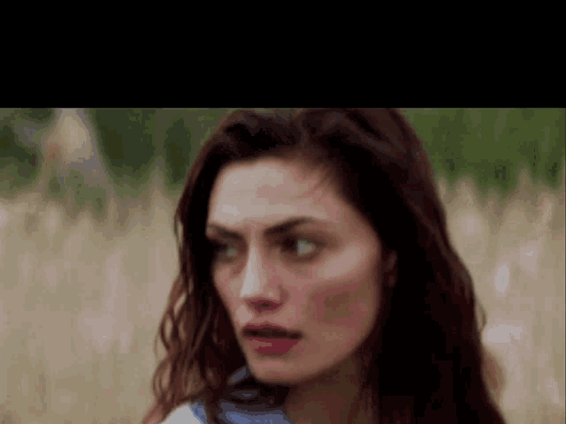 a close up of a woman 's face with her eyes closed
