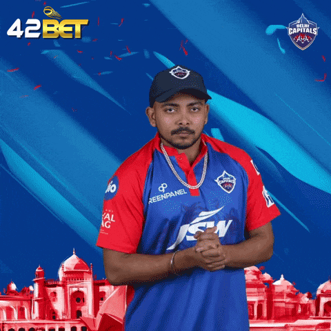 a man wearing a blue and red jersey with the word delhi carnival on it