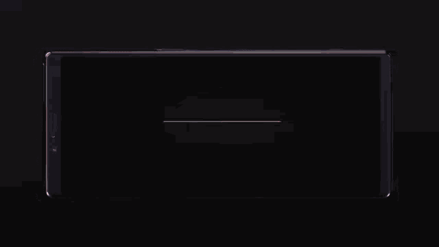a phone screen shows a sunset over a body of water