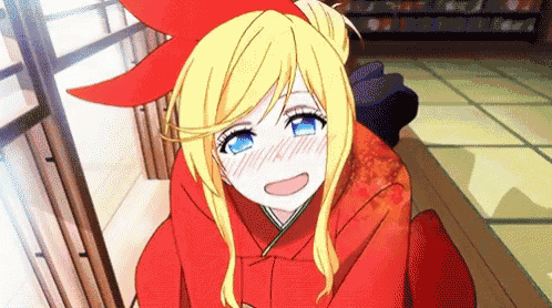 a girl with blonde hair and blue eyes is wearing a red kimono and smiling .