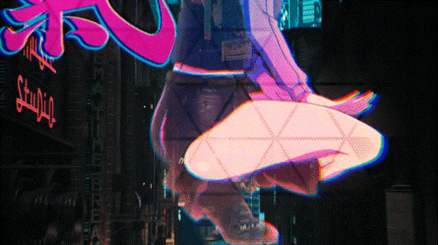 a neon sign that says studio is behind a person