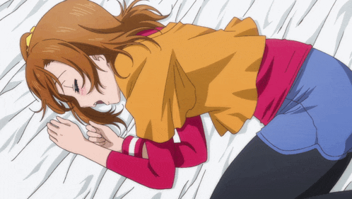 a girl is laying on a bed with her head on a pillow