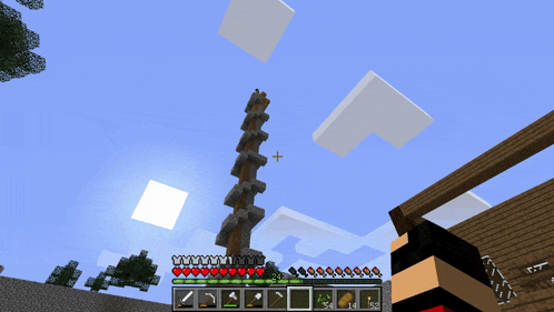 a screenshot of a minecraft game shows a tower with a cross in the middle