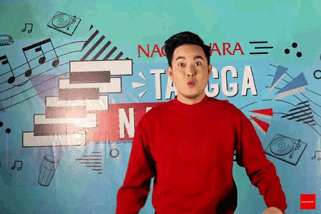 a man in a red sweater is standing in front of a sign that says nactara