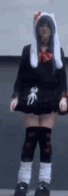 a woman in a hello kitty costume is standing in a room .
