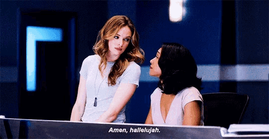 two women are sitting at a desk with the words amen hallelujah written on it