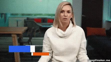 a woman in a white sweater is sitting in front of a blue , white and orange stripe .