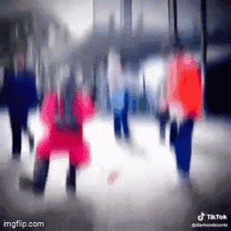 a blurry picture of a group of people walking down a street with tik tok written on the bottom