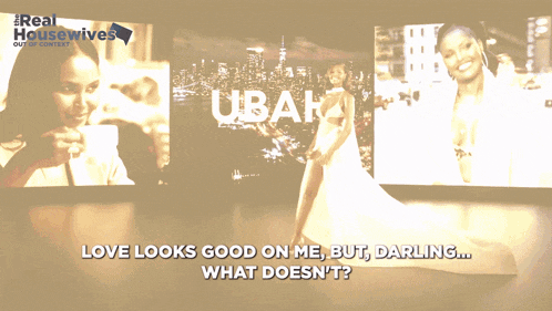 a woman in a white dress stands in front of a screen that says love looks good on me but darling what doesn t