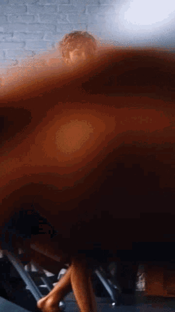 a blurred image of a woman 's legs and feet