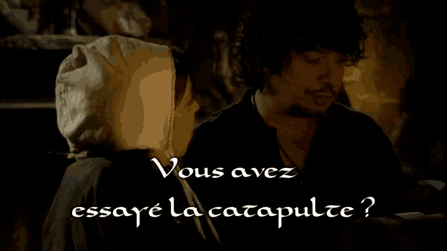 a man and a woman looking at each other with the words vous avez essaye la catapulte below them