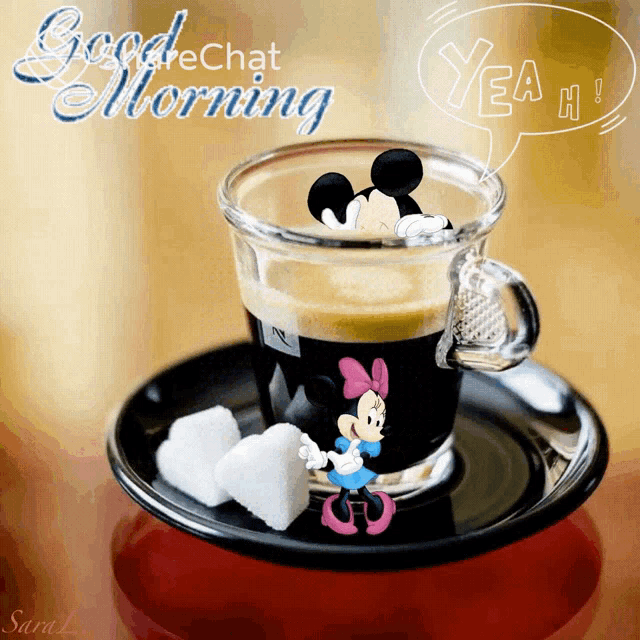 a cup of coffee with mickey mouse and minnie mouse on it is on a saucer