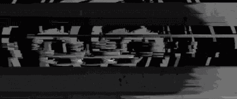 a black and white image of a person 's face is being projected on a black background .