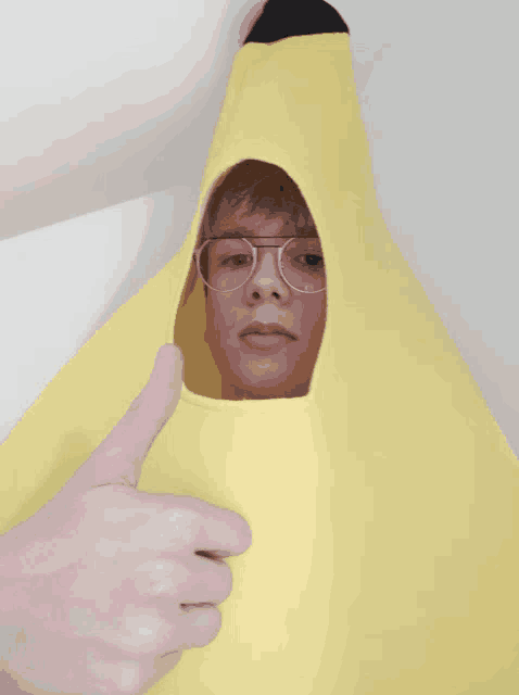 a person wearing a banana costume is giving a thumbs up