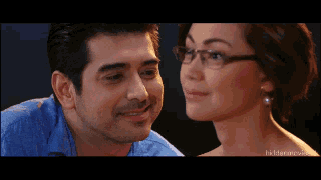 a man and woman are looking into each other 's eyes with a hiddenmovie.com logo in the corner