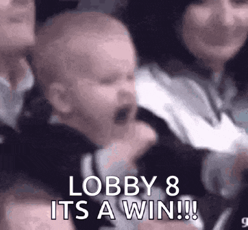 a baby is crying while sitting in a crowd of people .