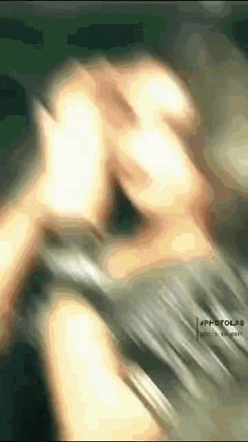 a blurry picture of a person 's face with a watermark that says photola
