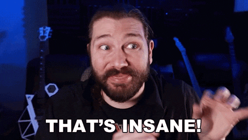 a man with a beard is making a face and saying that 's insane .