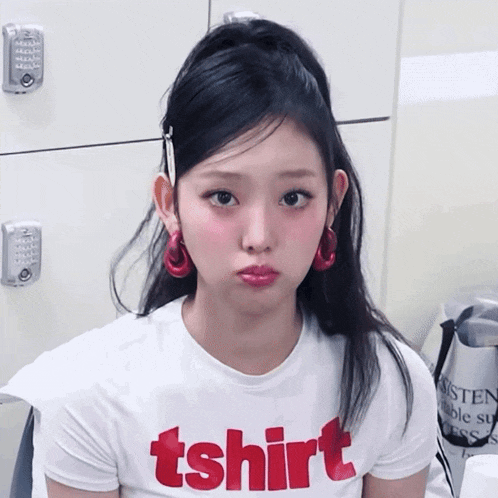 a woman wearing a white t-shirt that says tshirt