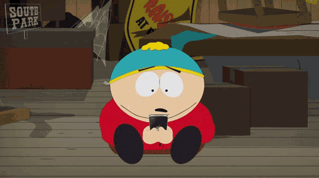 a cartoon character from south park is sitting on the floor looking at his cell phone