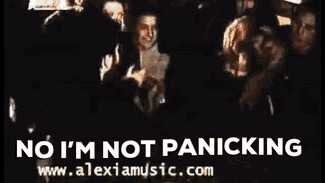 a group of people are standing in a dark room with the words no i 'm not panicking