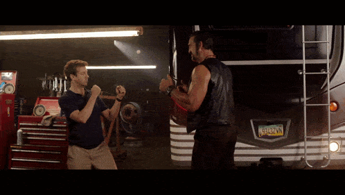 two men are fighting in front of a rv with a new york license plate number