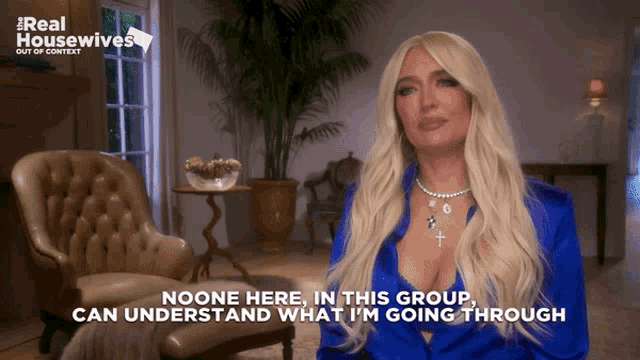 a woman in a blue shirt is talking about real housewives