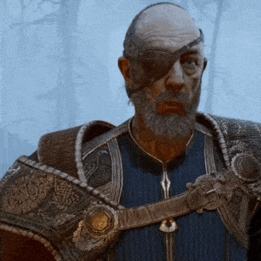 a man with a beard and an eye patch is wearing a blue shirt