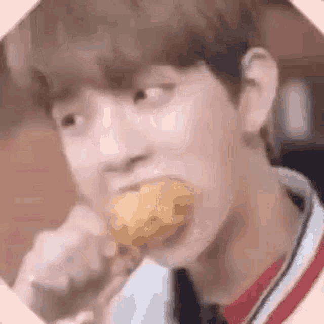 a young man is eating a chicken nugget with a fork .