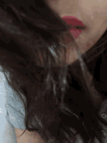 a close up of a woman 's face with a lot of hair