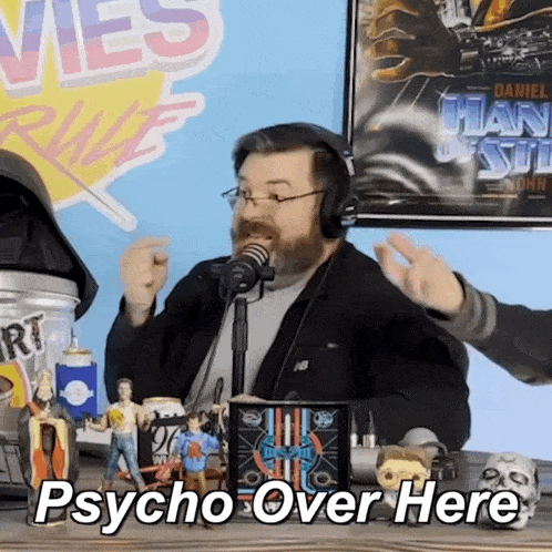 a man wearing headphones says psycho over here in front of a microphone