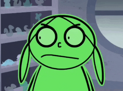 a green cartoon character is making a funny face in front of a shelf .