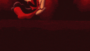a blurred image of a clown 's face with a red background