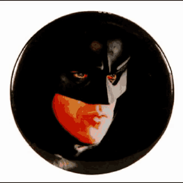 a button with a picture of a man in a batman mask on it