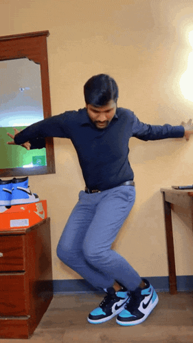 a man wearing a pair of nike shoes is dancing