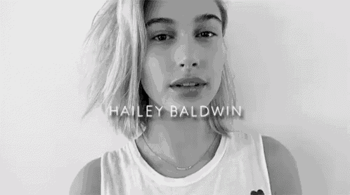 a black and white photo of hailey baldwin in a tank top