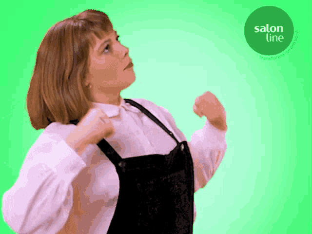 a woman is dancing in front of a green background with a salon line logo