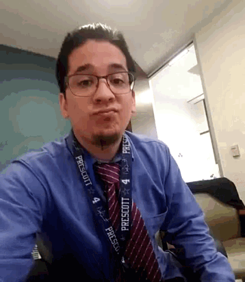 a man wearing glasses and a lanyard that says prescott on it