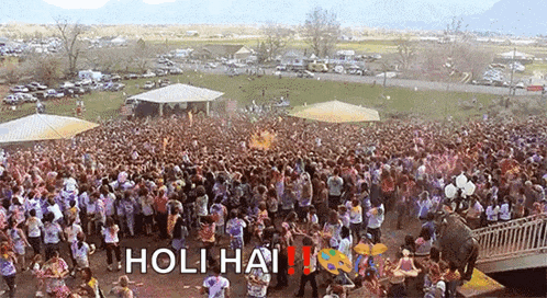 a large crowd of people are gathered in a park with the words holi hai written on the bottom