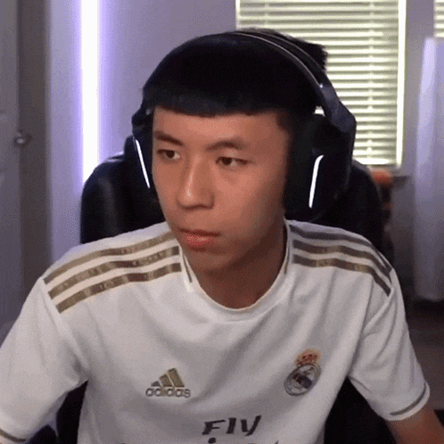 a man wearing headphones and a white adidas jersey