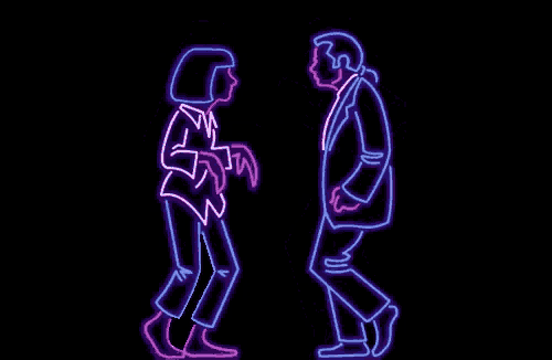 a neon sign of a man and a woman dancing in a dark room .