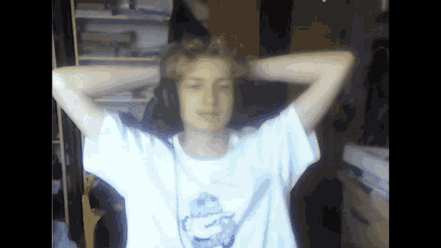 a boy wearing headphones and a white shirt with a picture of a bird on it