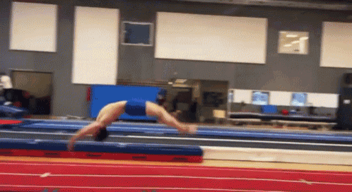 a gymnast is doing a handstand on a mat that says ' a ' on it