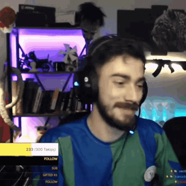 a man wearing headphones and a shirt that says follow on the bottom