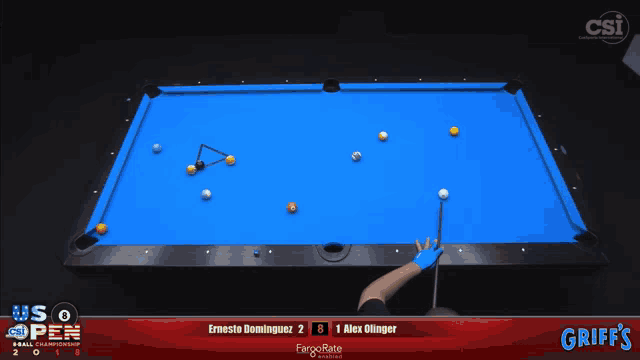 a pool table with a blue cloth and a diamond logo on it